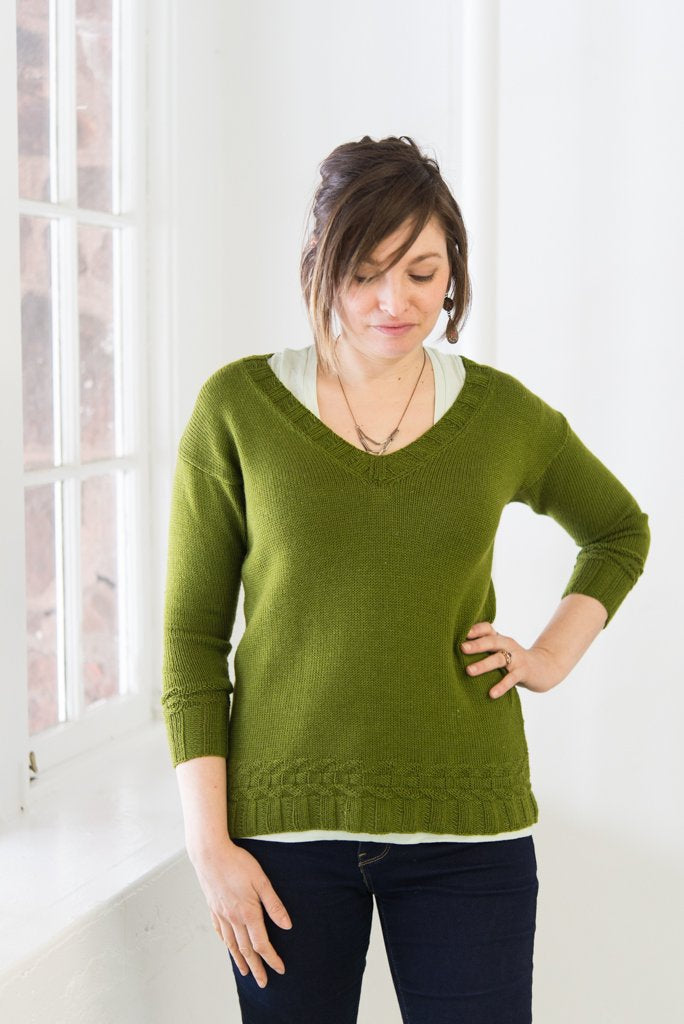 Green v-neck drop shoulder sweater, worn close fitting